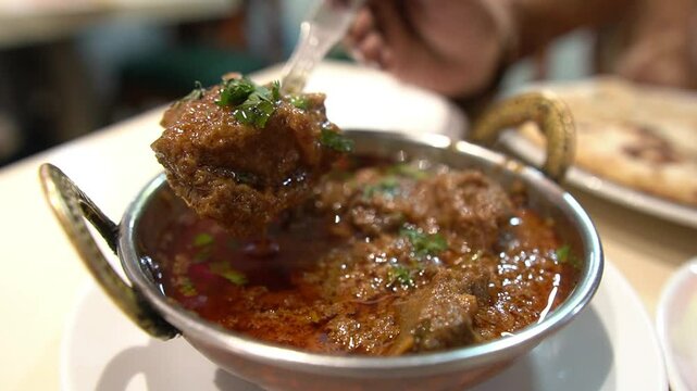 Closeu footage of Nihari mutton served at restaurant. Tender mutton pieces.