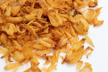 Stack of crispy fried onions isolated on white.