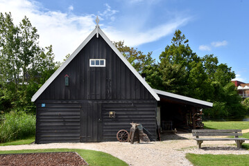 Broek op Langedijk, Netherlands. July17, 2023. Black tarred barns at Broek op Langedijk © Bert