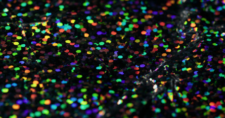 Glowing glitter. Confetti highlights. Iridescent surface with strobe disco effect. Variable dark background with spectral speckle dispersion.