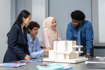 Architects engineers collaborating on building design project in modern office, diverse team of professionals female muslim architect and male engineers discussing architectural model of structure