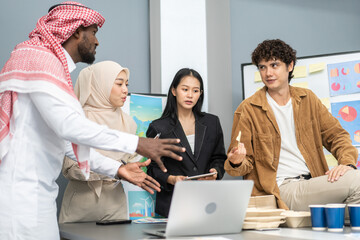 Diverse team professionals collaborating on sustainable development project during a corporate meeting, presentation eco-friendly designs with charts and data on renewable energy and green technology