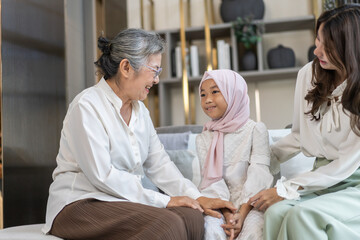 Multi generational asian family bonding at home, grandmother, mother, and daughter play together, happy family moments, diverse family values, joyful connection, smiling and warmth, candid lifestyle