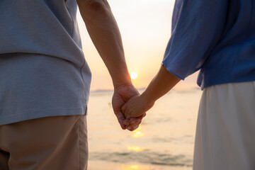 Happy active senior couple having fun enjoying a romantic getaway by the seaside.