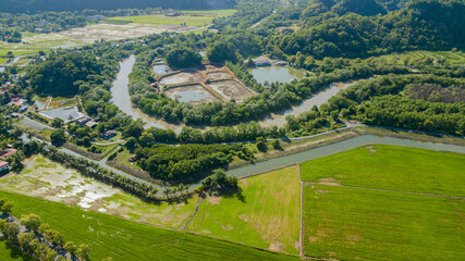 Aerial drone view of countryside with a river at Kampung Wai, Perlis, Malaysia