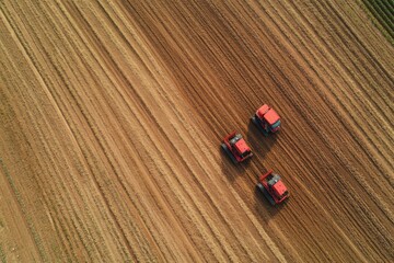 Fototapeta premium Automated farming machines work diligently to plant crops across a large field, creating systematic furrows in the earth. Generative AI