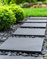 A serene garden path lined with dark stone slabs and pebbles, bordered by lush green shrubs, creating a tranquil outdoor space.