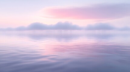 Serene sunrise over calm water with mist.