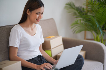 Asian woman preparing package delivery box Shipping for shopping online delivery mail service people and shipment concept