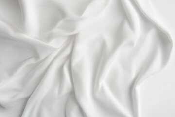 Obraz premium White silk fabric draped over a wooden chair with soft sunlight filtering through a nearby window, casting shadows on the delicate material.