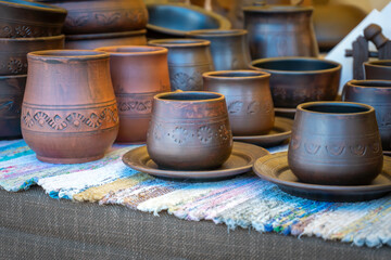 Traditional Pottery. Clay Cups, Jugs, Plates, and Bowls on a Craftsmans Stall.