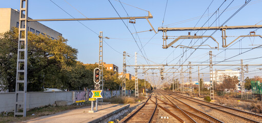 Train track with a yellow and black sign on the side