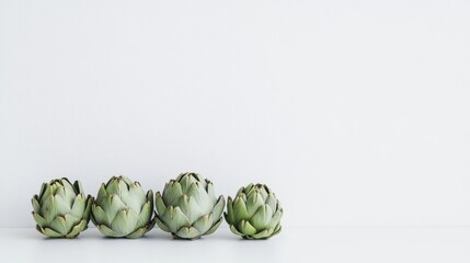 Fresh artichokes lined up against a clean white background highlighting their natural textures and colors, perfect for promoting healthy eating and organic produce.