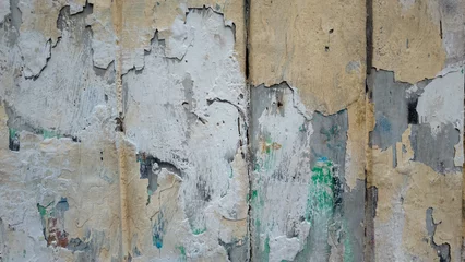 Textured damaged wall  with peeled old paper. Old wood texture with peeling paint © inaann