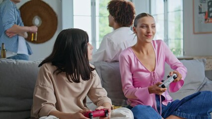 Video gamers have fun playing together home meeting closeup. Girls competition