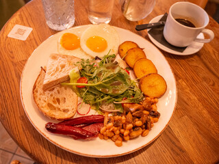 salad, sunny side up, and beans on the plate in cafe of capital kyiv