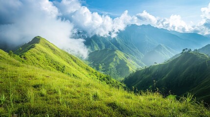 Obraz premium Majestic Green Mountains Under a Bright Sky with Lush Vegetation and Rolling Hills Surrounded by Soft Clouds