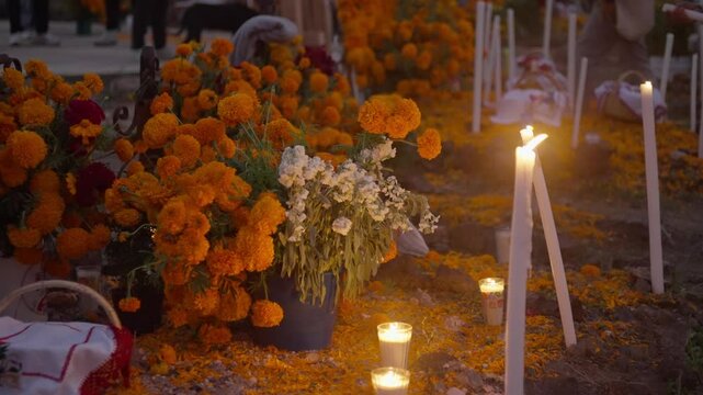 SLOW MOTION SHOT OF CANDLES AND TOMBS AT JANITZIO ISLAND ON DAY OF THE DEATH