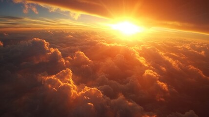 Stunning aerial view of a fiery sunset illuminating fluffy clouds from an airplane window, creating a picturesque and serene sky scene.
