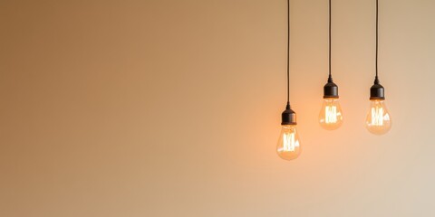 Three Edison Bulbs Hanging Against a Beige Wall