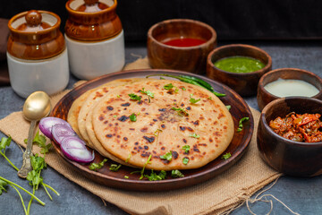 Aloo paratha is a popular North Indian dish, especially in Punjab, Uttar Pradesh, and Bihar. It's a stuffed flatbread with spiced mashed potatoes, served with pickles (anchar)  and  butter 