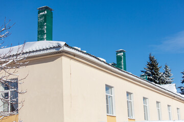 A building with a green chimney on top