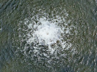 A small stream of water is coming out of a fountain