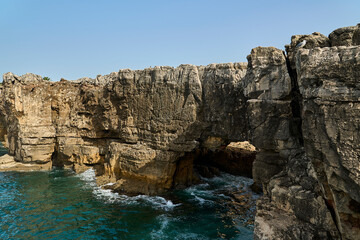 waves breaking at the rugged rocky coastline at cabo da roca.