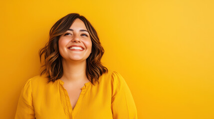 Obraz premium Smiling Mexican woman in yellow top against matching yellow background