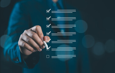 Businessman use pen to virtual tick correct sign mark for project and document approval, Quality...