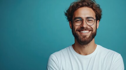 Obraz premium Happy businessman celebrating success against a blue background, with space for text.