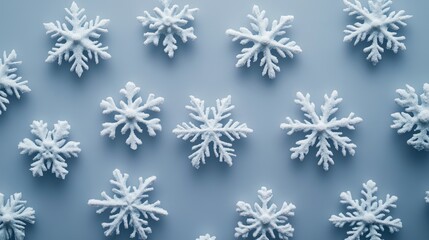 A scattering of frosty white snowflakes on a cool blue background.