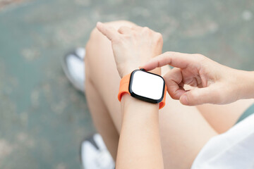 Close up of woman in check on smartwatch after running