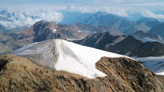 Experience the stunning views from the summit of Wildspitze, the highest mountain in the Otztal Alps, showcasing its majestic landscape and surrounding peaks.