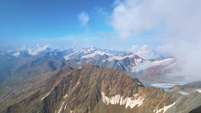 Experience breathtaking panoramic views from the summit of Wildspitze, the highest peak in the Otztal Alps, showcasing the stunning landscape of North Tyrol, Austria.