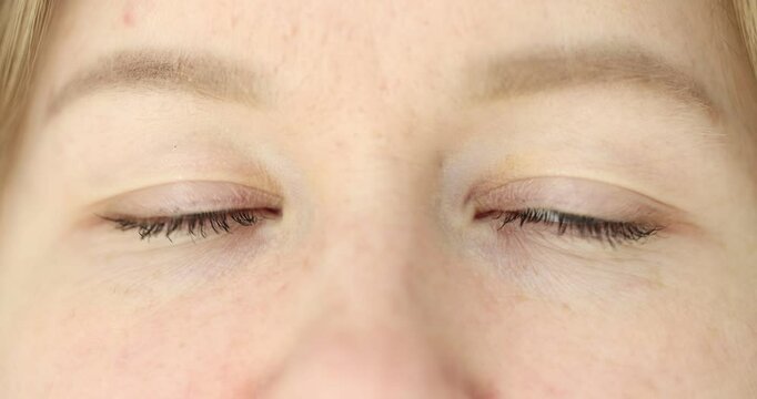 Closeup of woman eyes with light brown eyebrows