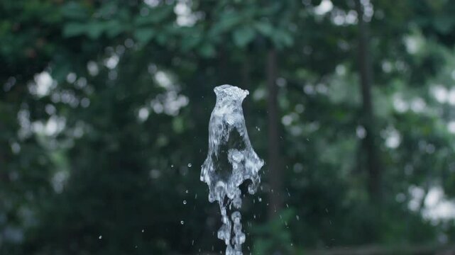 Outdoor Water Fountain Spraying Up In Slow Motion.