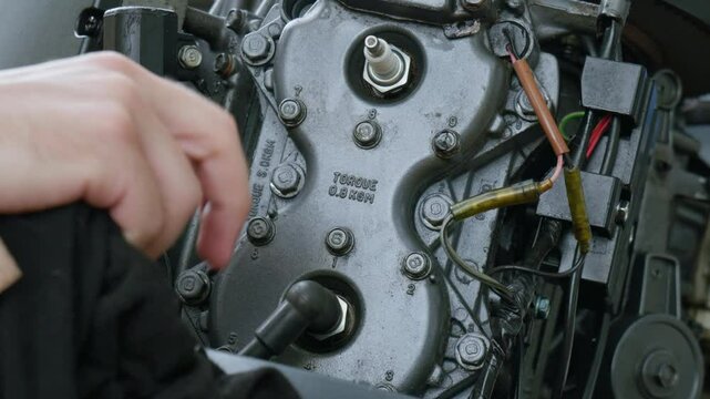 Boat outboard motor maintenance by an Australian Caucasian male. Outdoors, daytime, clip 1