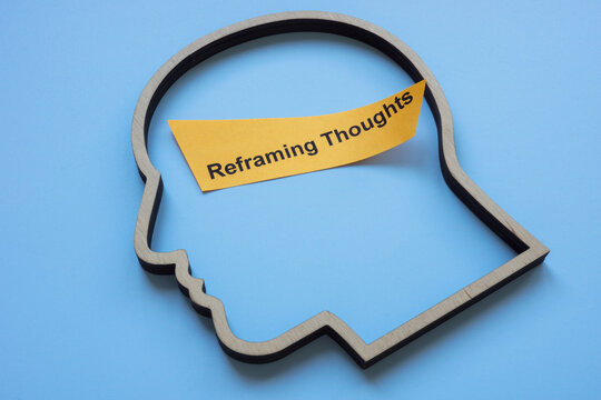 Outline of a head with the phrase reframing thoughts. Mindset shift and cognitive transformation.