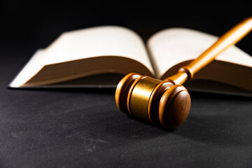 Judge gavel on a wooden desk, law books