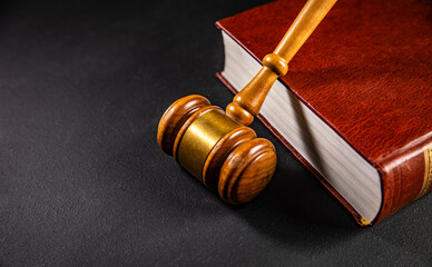 Judge gavel on a wooden desk, law books