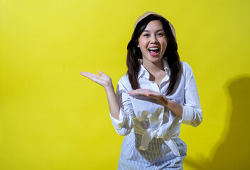 Asian woman wearing a white shirt, striped skirt, and beige bucket hat, posing with an enthusiastic...