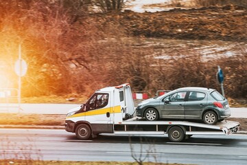 Flatbed Truck Transports Damaged Car Safely