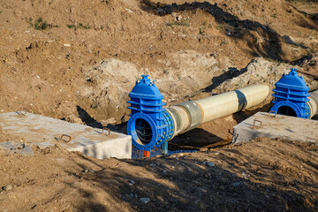 New fiber glass water pipeline in trench. Replacement of old rusty tubes by new one