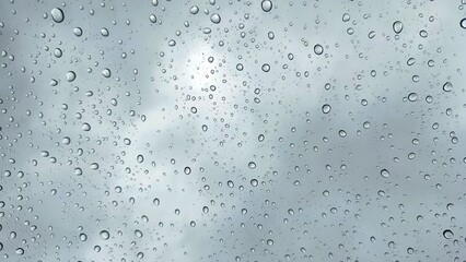 water drops on glass. Water droplets perspective through glass surface against blue sky good for...