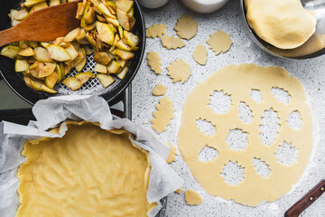 fall recipe preparation process of half-open apple pie with autumn leaves decor