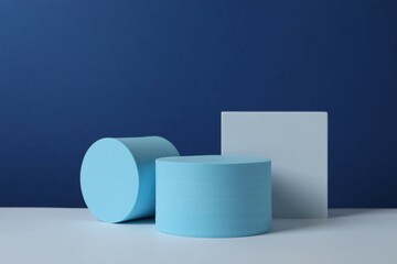 White podiums on color background 