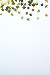 Beautiful golden confetti on a white background