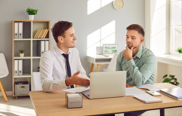 Businessman discussing a job vacancy with a candidate or talking with a client. Scene captures the essence of HR discussions and client interactions within the professional office setting.