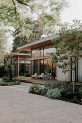 Obraz premium Modern Contemporary Home with Floor-to-Ceiling Windows and Beautiful Landscaping